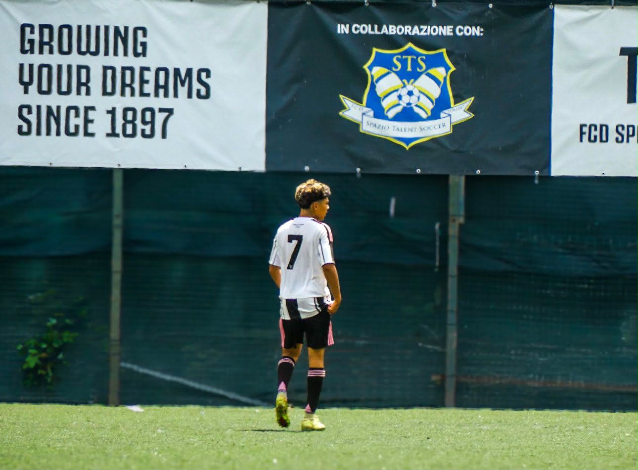 Eric in front of the Growing Your Dreams Since 1897 banner