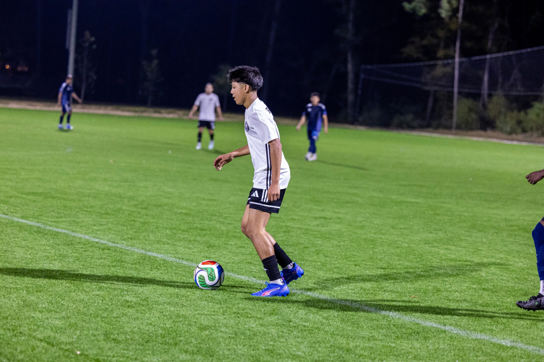 Eric carrying the ball near the touchline