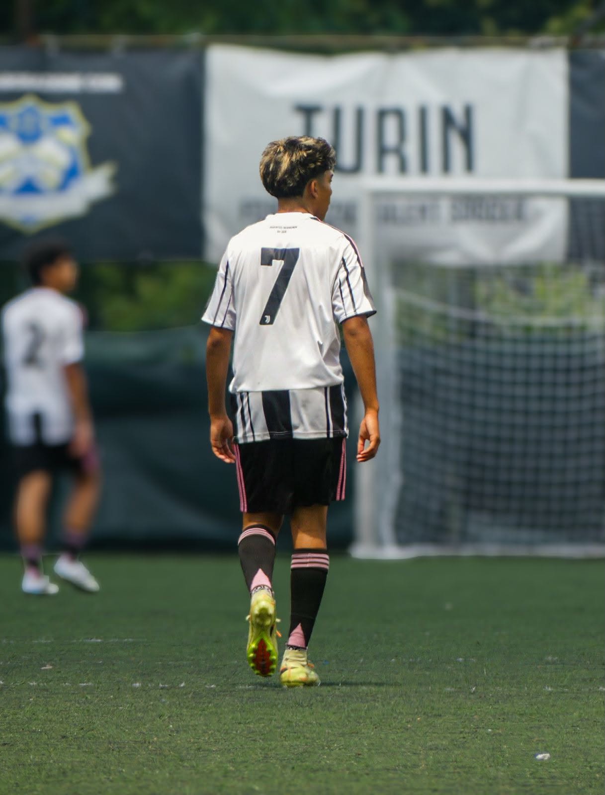 Eric wearing #7 in front of the Turin banner