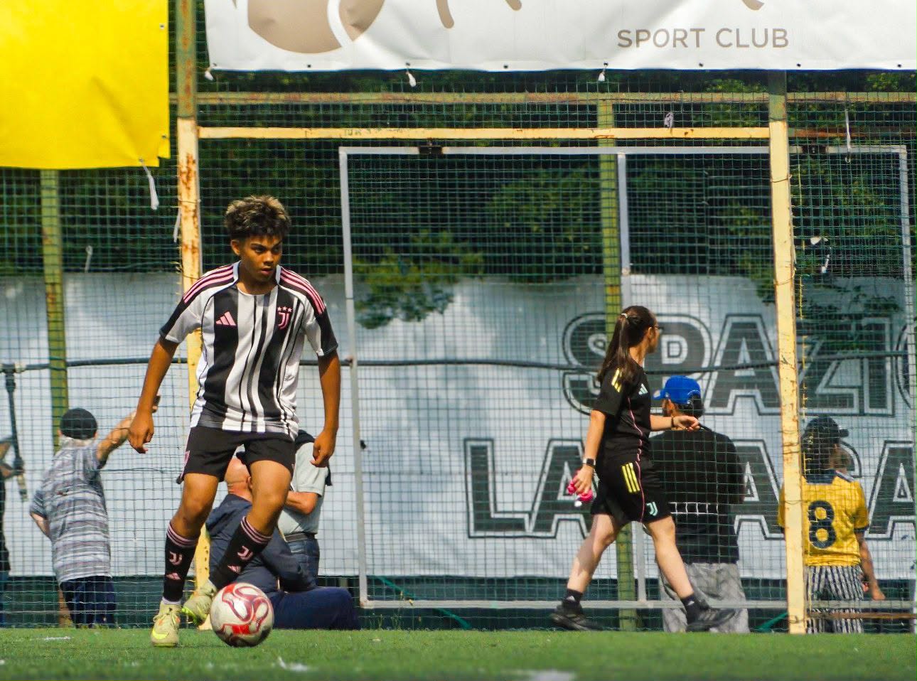 Eric on the ball in front of the Sport Club banner