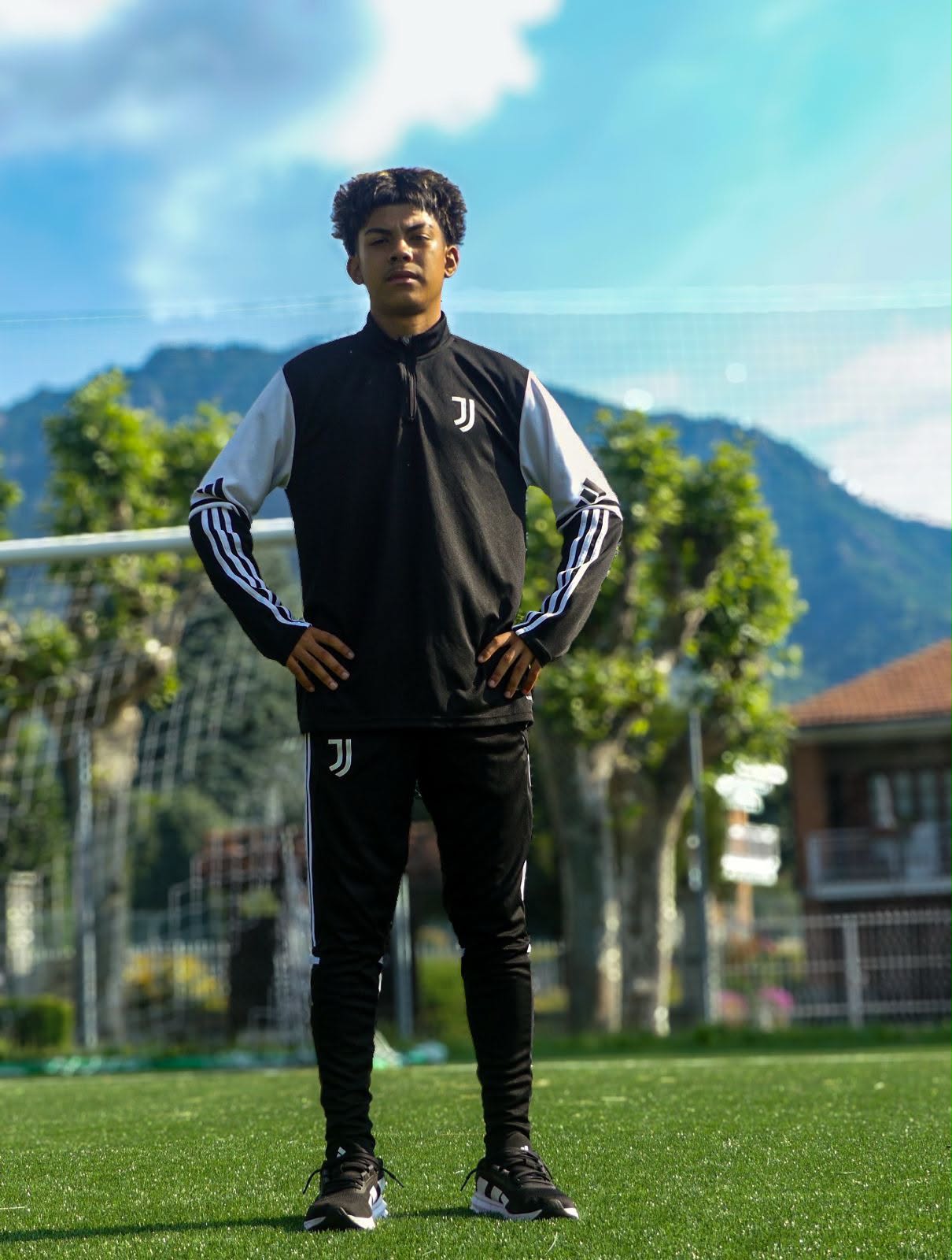 Eric in Juventus tracksuit with mountains in the background