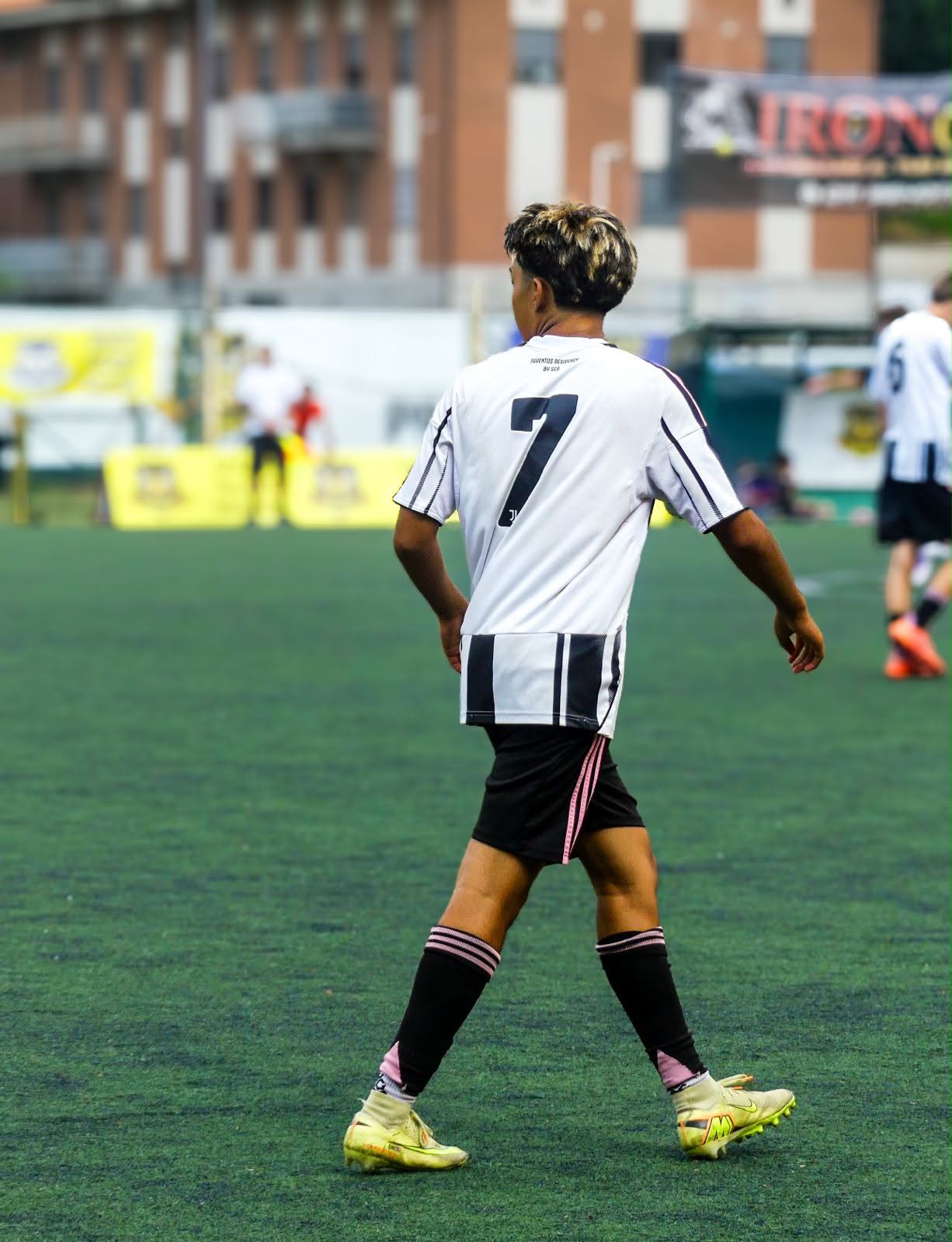 Eric walking the pitch in Juventus #7 with stadium in background