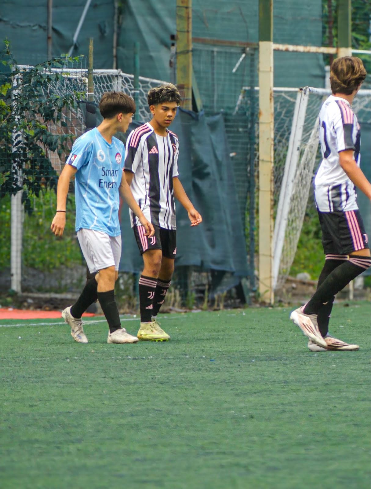 Eric on the pitch between two opponents